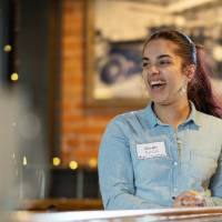 Event attendee laughing at something off camera